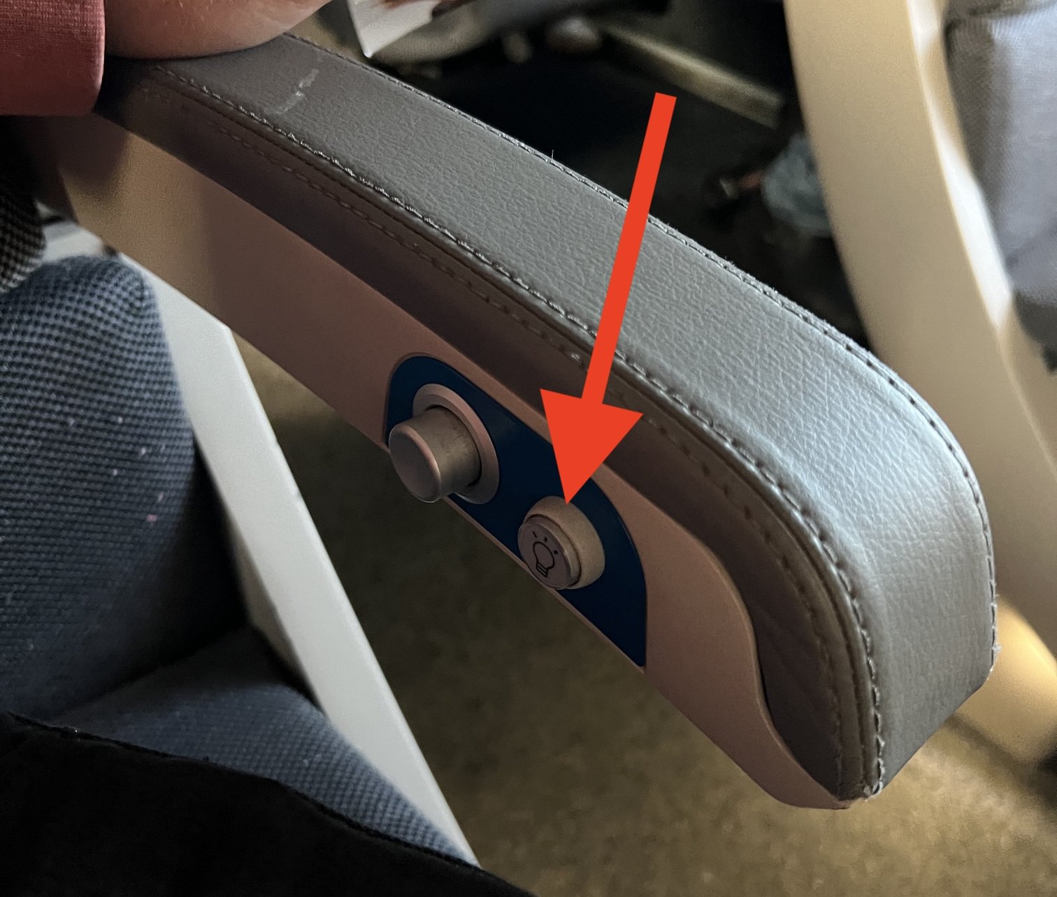 Train reading light button positioned at elbow level